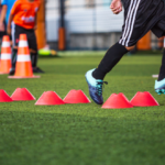 soccer-ball-tactics-grass-field-with-barrier-cone-training-children-jump-skill-soccer-academy