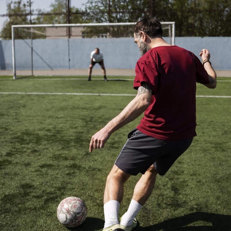full-shot-men-playing-soccer