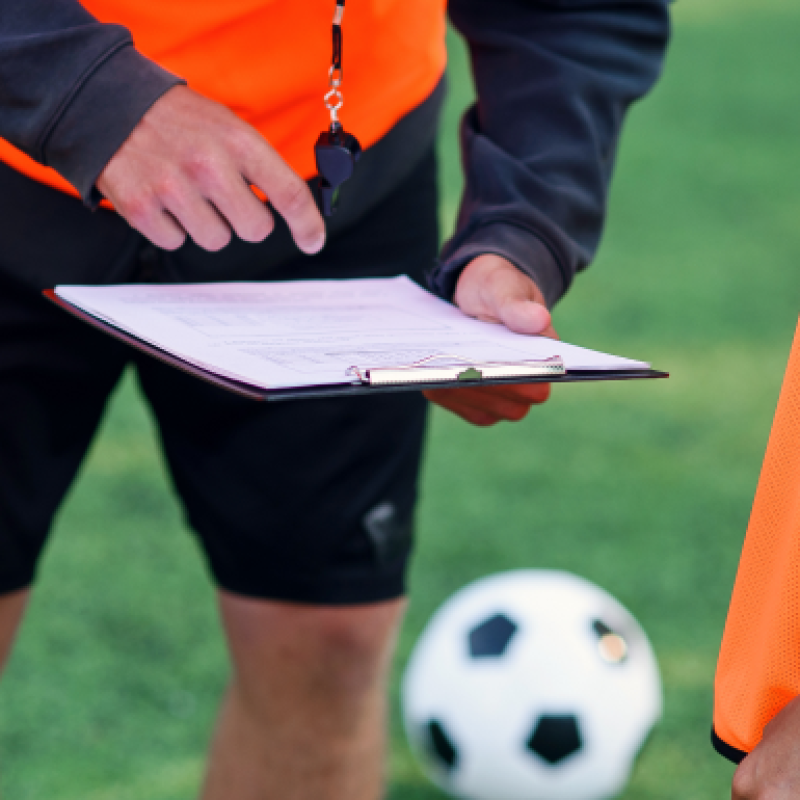 soccer-coach-shows-strategy-football-game-his-players-training